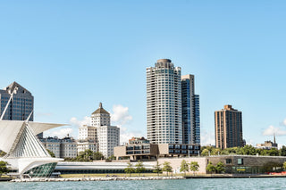 Sunny and clear Milwaukee skyline featuring art museum and high-rise buildings on the shore of Milwaukee Bay in Lake Michigan